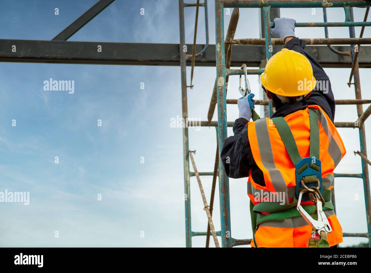 El trabajador asiático usa equipo de seguridad de altura. Dispositivo de  protección contra caídas para trabajadores con ganchos para arnés de cuerpo  de seguridad, trabajador como en el sitio de construcción Fotografía