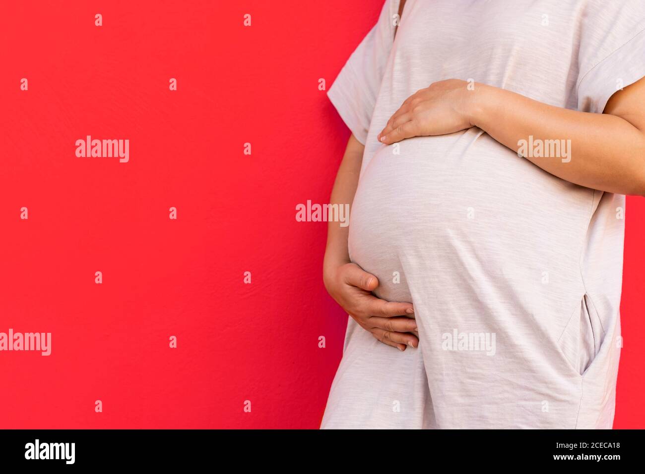 Mujer embarazada feliz y esperando bebé en casa. Foto de stock