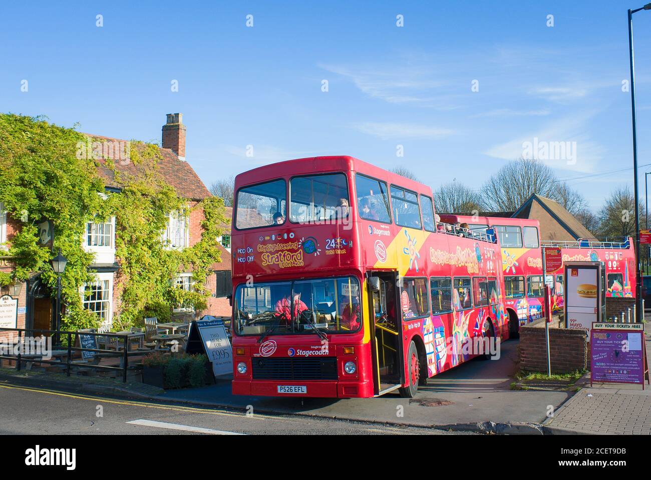 Autobuses turísticos de dos pisos en Stratford on Avon Warwickshire Inglaterra Reino Unido jugando su parte en mostrar a los turistas visitantes los muchos históricos sitios en el remolque Foto de stock