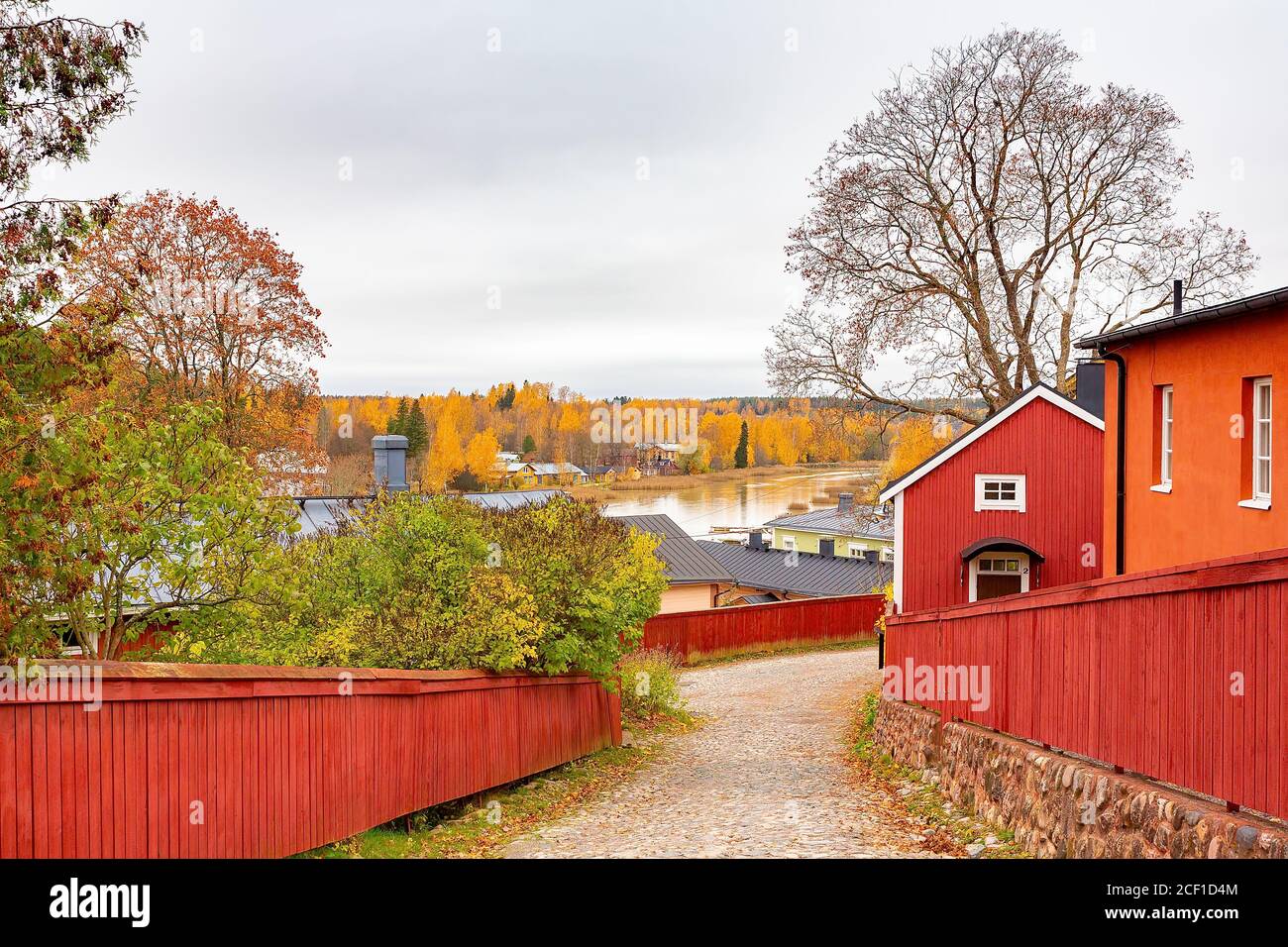 Paisaje finlandés con cercas de madera roja y casas a lo largo de la río en Porvo Foto de stock