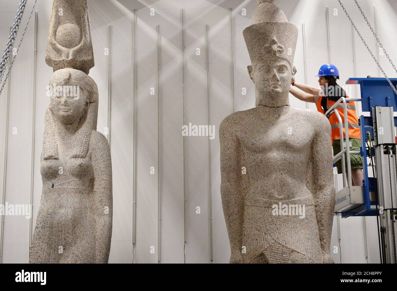 El personal del Museo Británico trabaja para instalar dos estatuas colosales de un rey y una reina, posiblemente del reinado de Ptolomeo II (283-246 AC), pero se retractan más tarde. El rey tiene 5m de altura y la reina tiene 4,9m. Ambos están hechos de granito rosa y fueron descubiertos por Franck Goddio en el sitio de Thonis-Heracleion y formarán parte de la exposición de BP Ciudades hunidas: Los mundos perdidos de Egipto que se extiende del 19 de mayo al 27 de noviembre de 2016 en el Museo Británico en Londres. Foto de stock