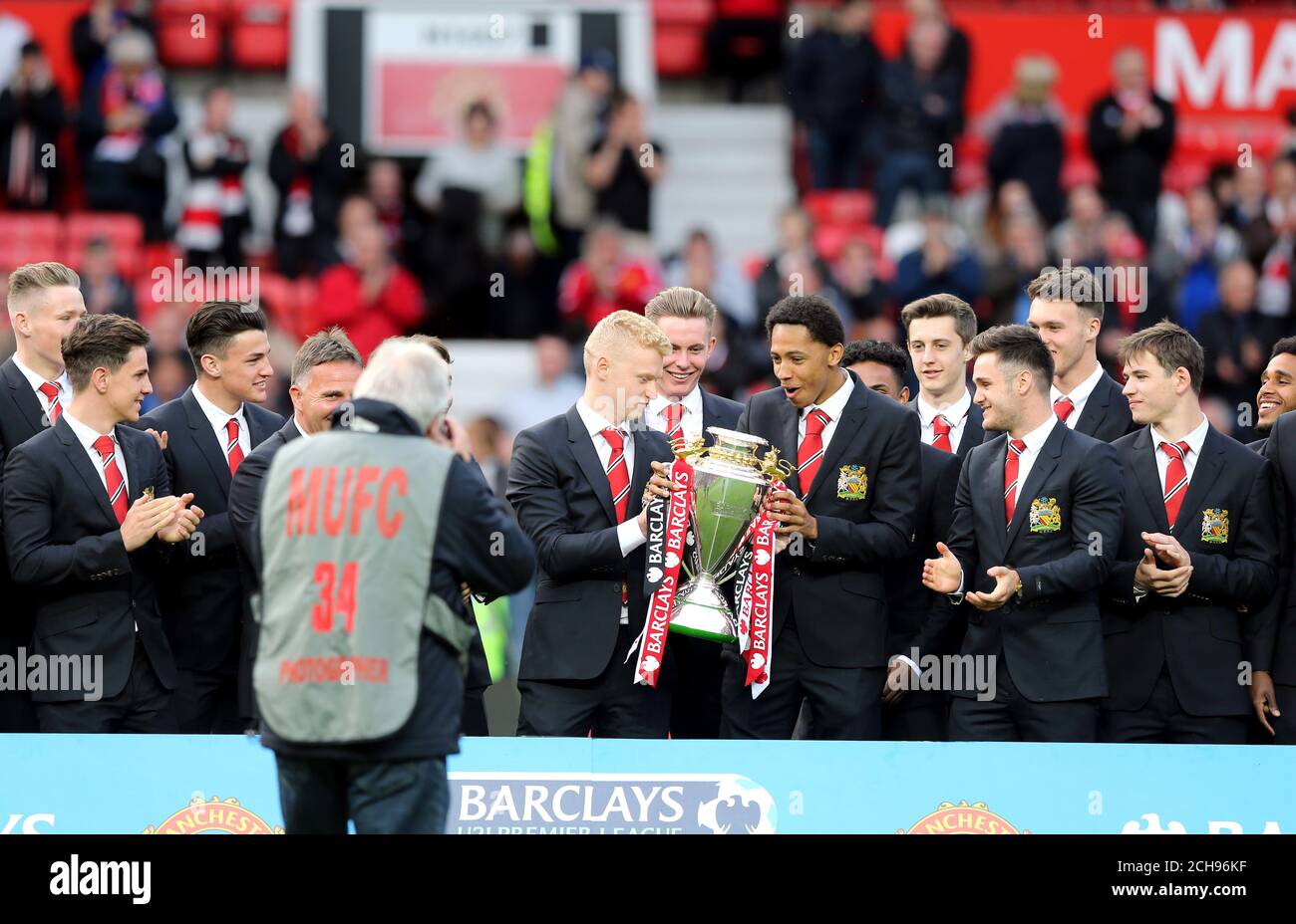 James Weir del Manchester United U21 y el gerente Warren Joyce desfilan el trofeo por ganar la Barclays U21 Premier League durante el partido Barclays Premier League en Old Trafford, Manchester. Foto de stock