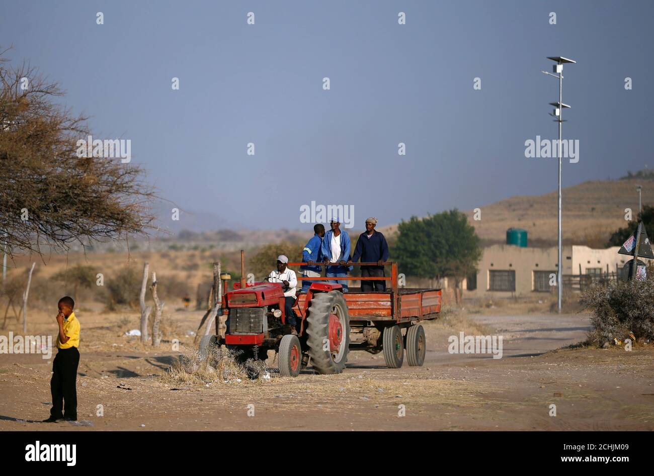Los hombres viajan detrás de un tractor en la aldea de Mapela cerca de la mina de platino Mogalakwena en Mokopane, provincia de Limpopo, Sudáfrica, 20 de septiembre de 2017. Foto tomada el 20 de septiembre de 2017. Para igualar Insight ÁFRICA-PLATINUM/. REUTERS/Siphiwe Sibeko Foto de stock