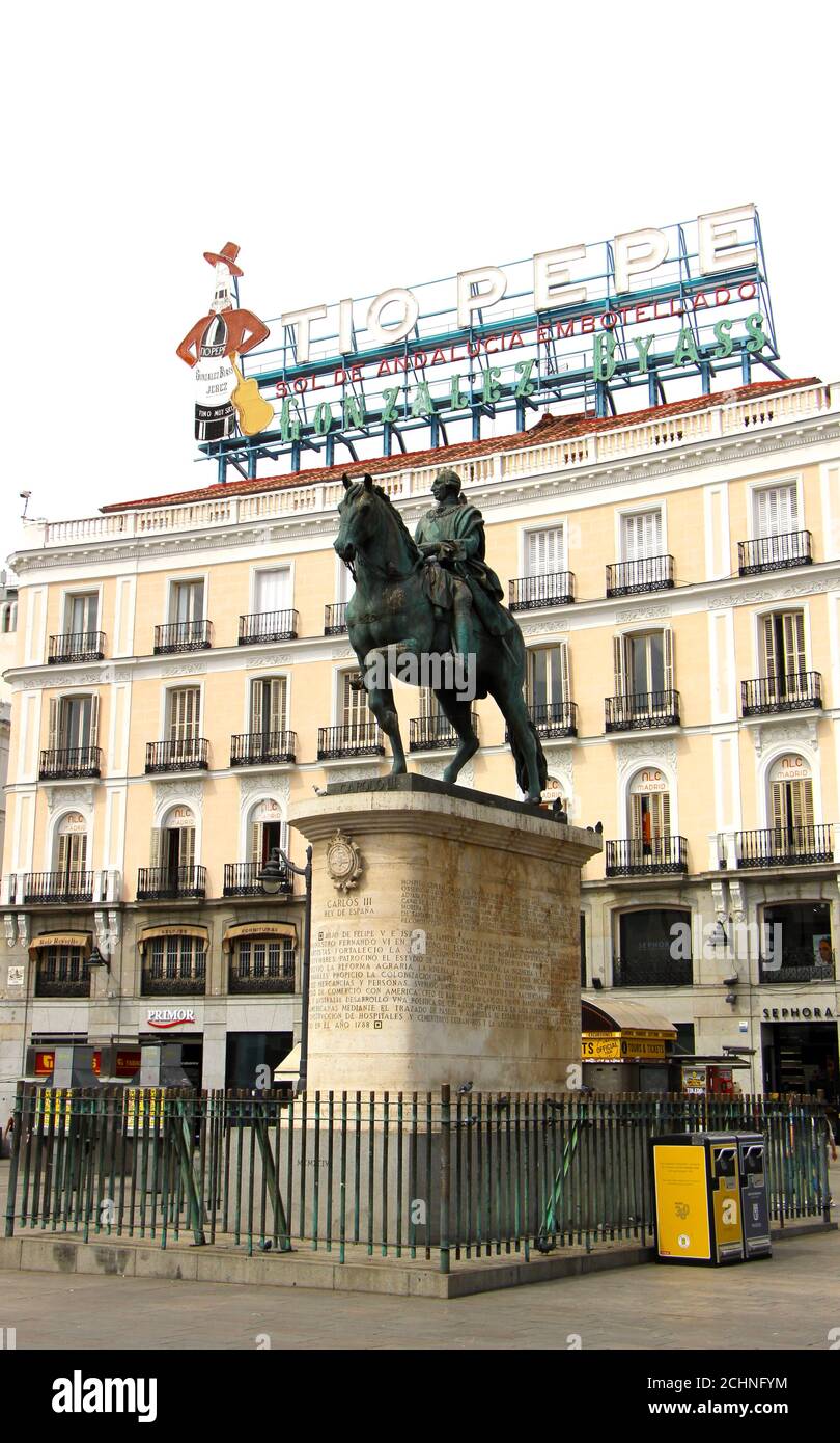 Estatua de bronce de Carlos III Rey de España a caballo en un alto plinto en la puerta del Sol plaza en el centro de Madrid España Verano Foto de stock