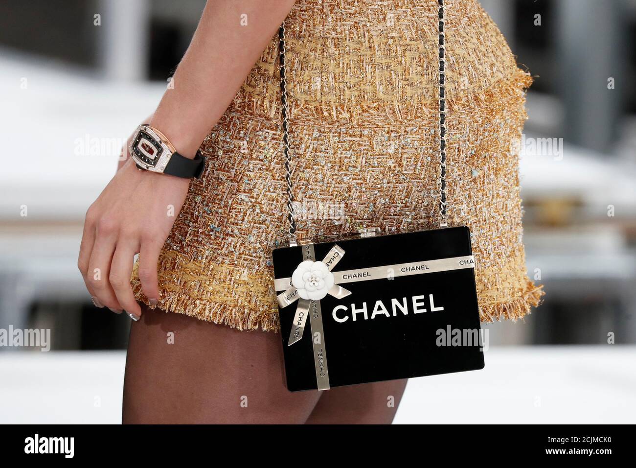 A guest holds a chanel handbag as she arrives to attend the German designer  Karl Lagerfeld Fall/Winter 2017-2018 women's ready-to-wear collection for  fashion house Chanel during Fashion Week in Paris, France March