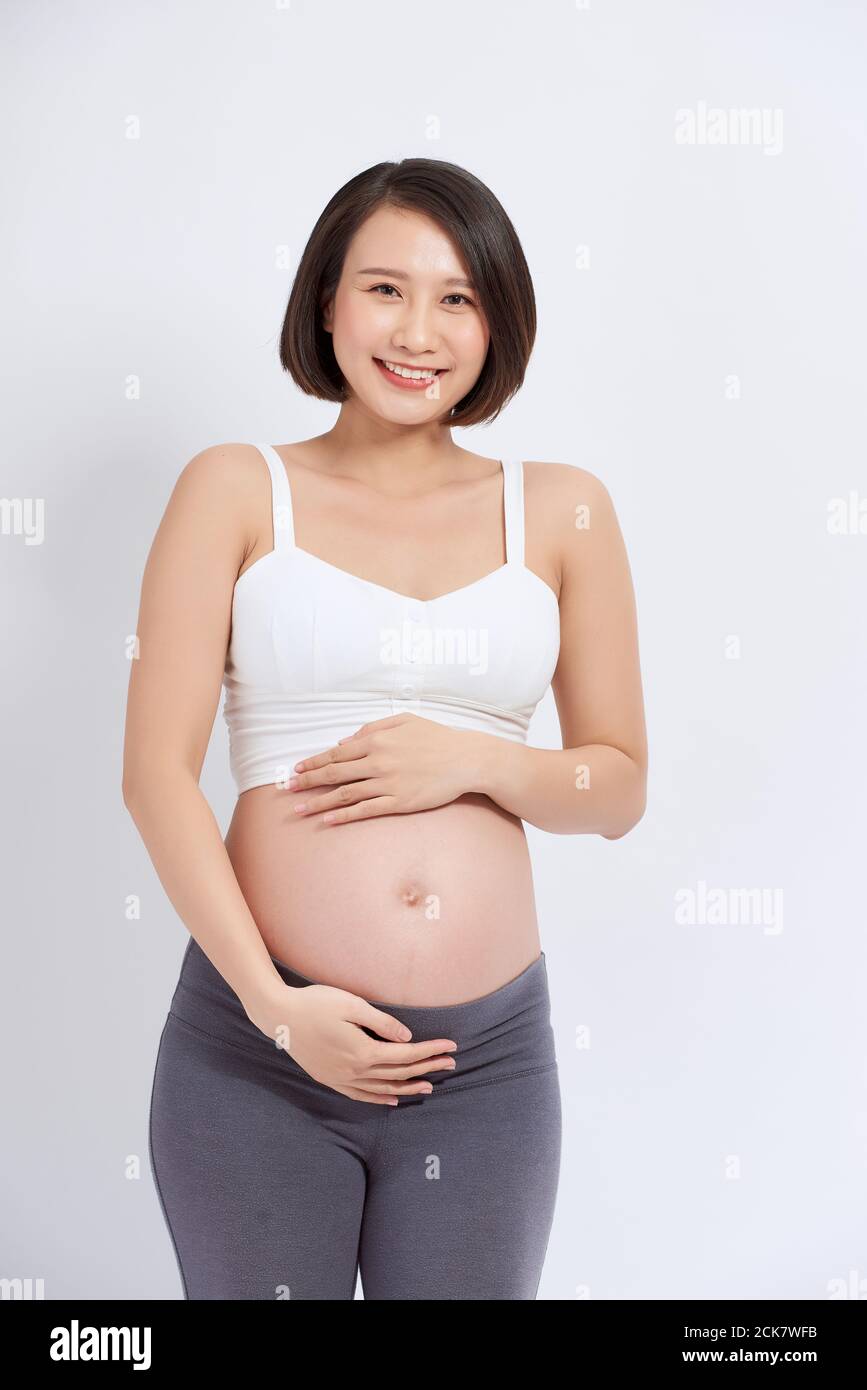 La joven que espera que la madre tenga a su bebé en el vientre embarazada. Foto de stock