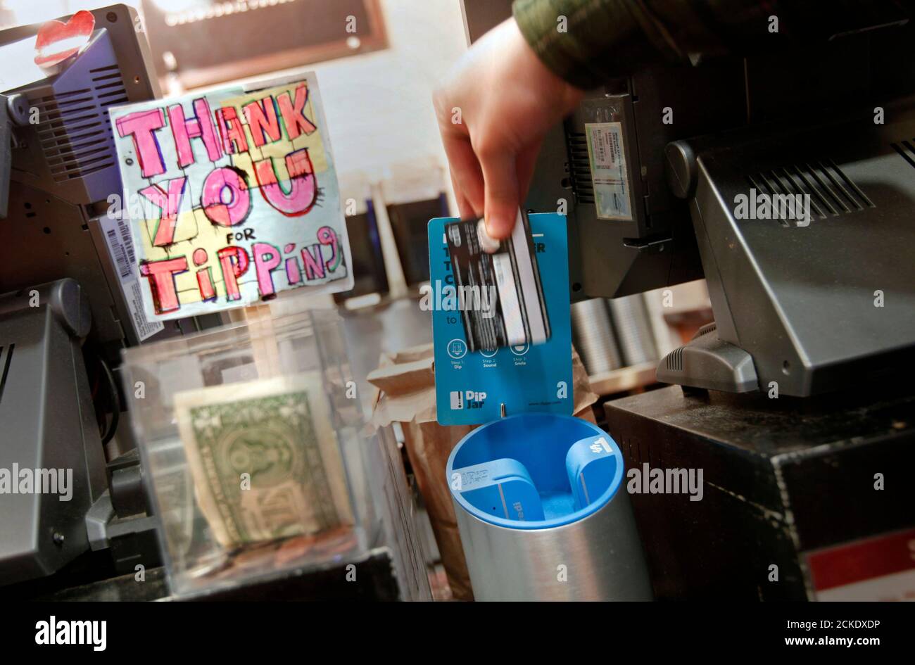 A Man Demonstrates The Use Of A Dipjar An Electronic Version Of The Tip Jar Found In Coffee Shops On The Counter Of An Oren S Daily Roast In New York February 13