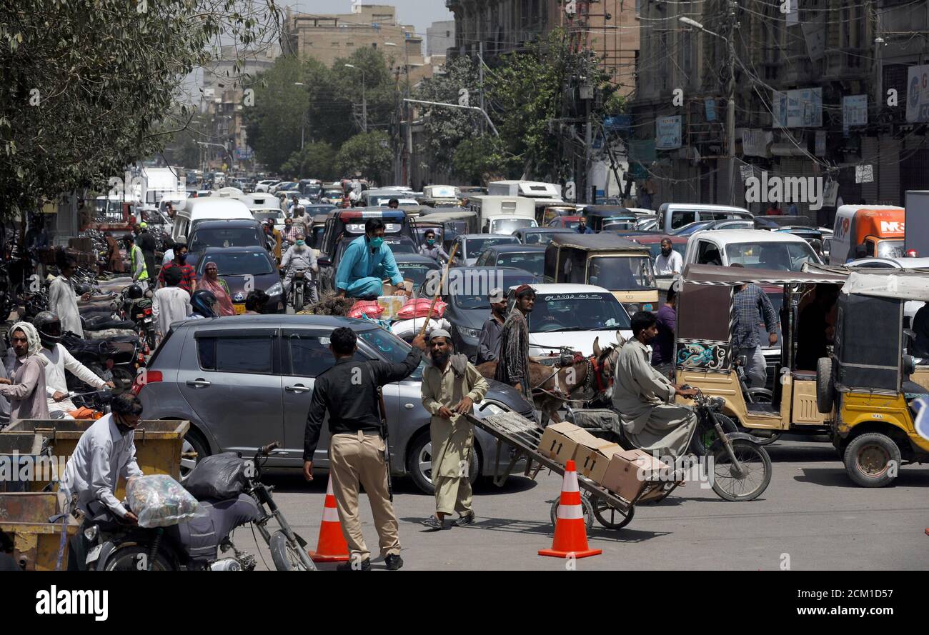 Un oficial de policía agita una porra mientras está tratando de controlar el tráfico, después de que Pakistán anunció dos semanas de extensión de un bloqueo en todo el país, pero levantar algunos corderos, después de la propagación de la enfermedad del coronavirus (COVID-19), en Karachi, Pakistán, 15 de abril de 2020. REUTERS/Akhtar Soomro Foto de stock