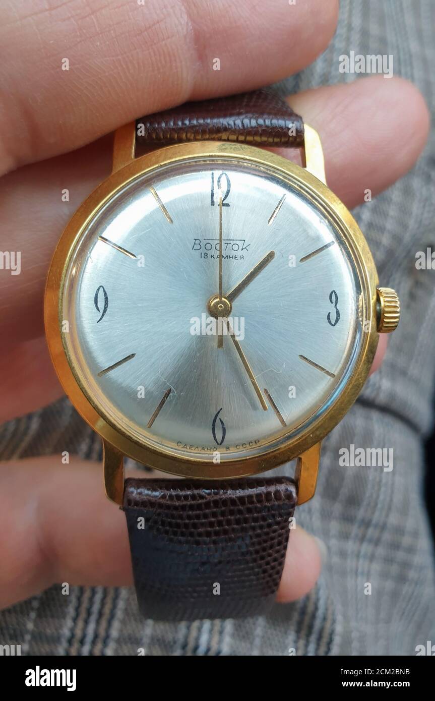 Editorial ilustrativa: Vostok Vintage reloj mecánico ruso en la mano. Viejo  reloj de la era del soviético de la guerra fría con el caso de oro. Arte  retro communis Fotografía de stock -