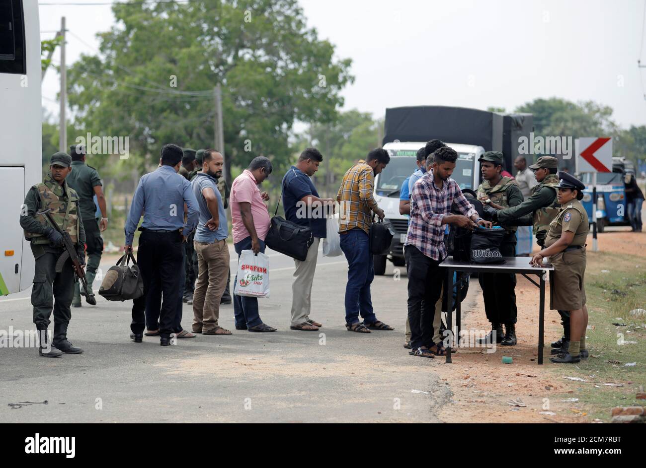 El personal del ejército de Sri Lanka busca a personas y sus bolsos en un punto de control en la aldea de Kattankudy en Batticaloa, Sri Lanka, 28 de abril de 2019. REUTERS/Dinuka Liyanawatte Foto de stock