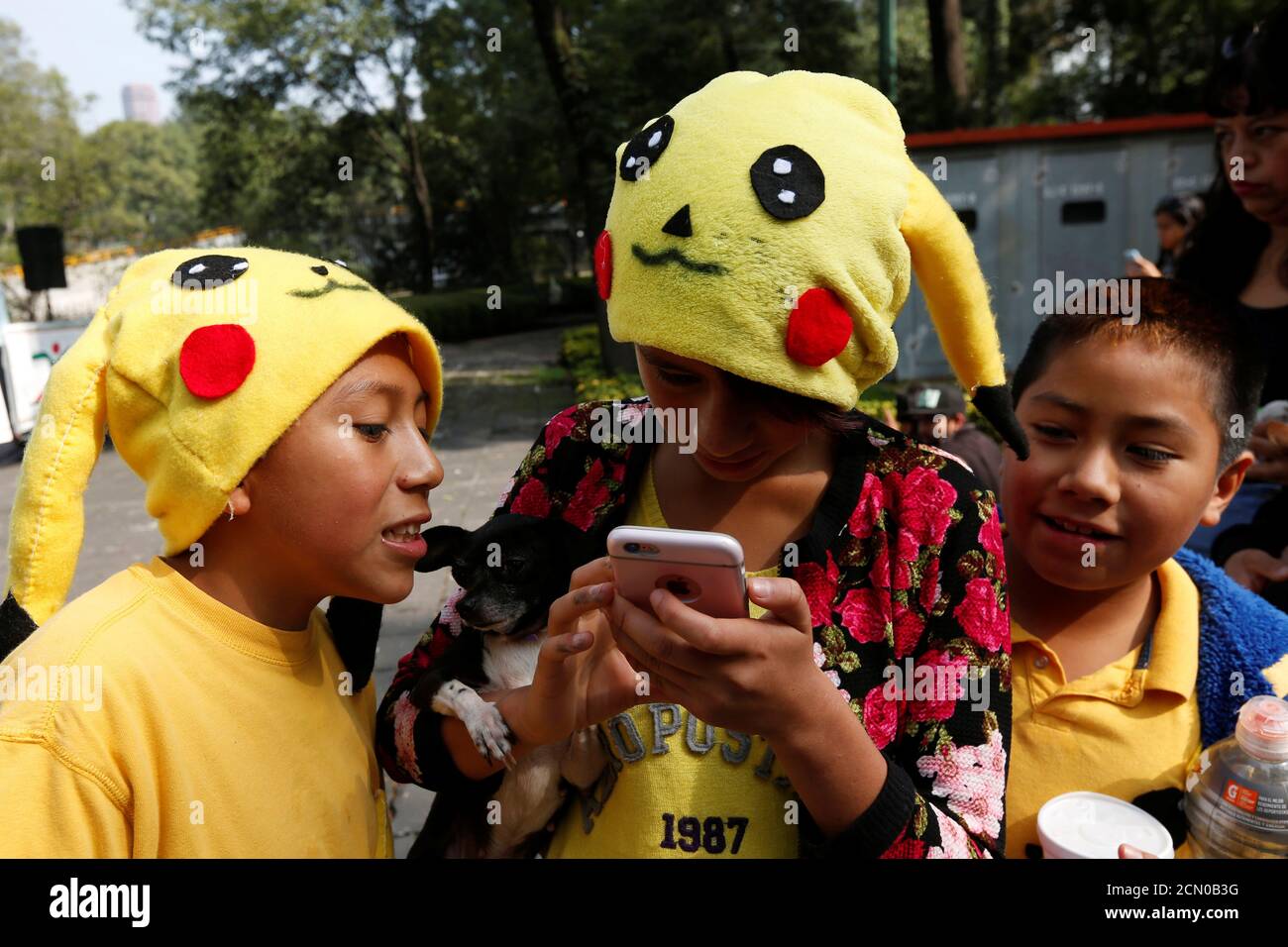 Admitir Ofensa Sicilia Los niños que llevan sombreros de un personaje de Pokemon, Pikachu, juegan  a Pokemon Go durante una reunión para celebrar el "día de Pokemon" en la  Ciudad de México, México 21 de