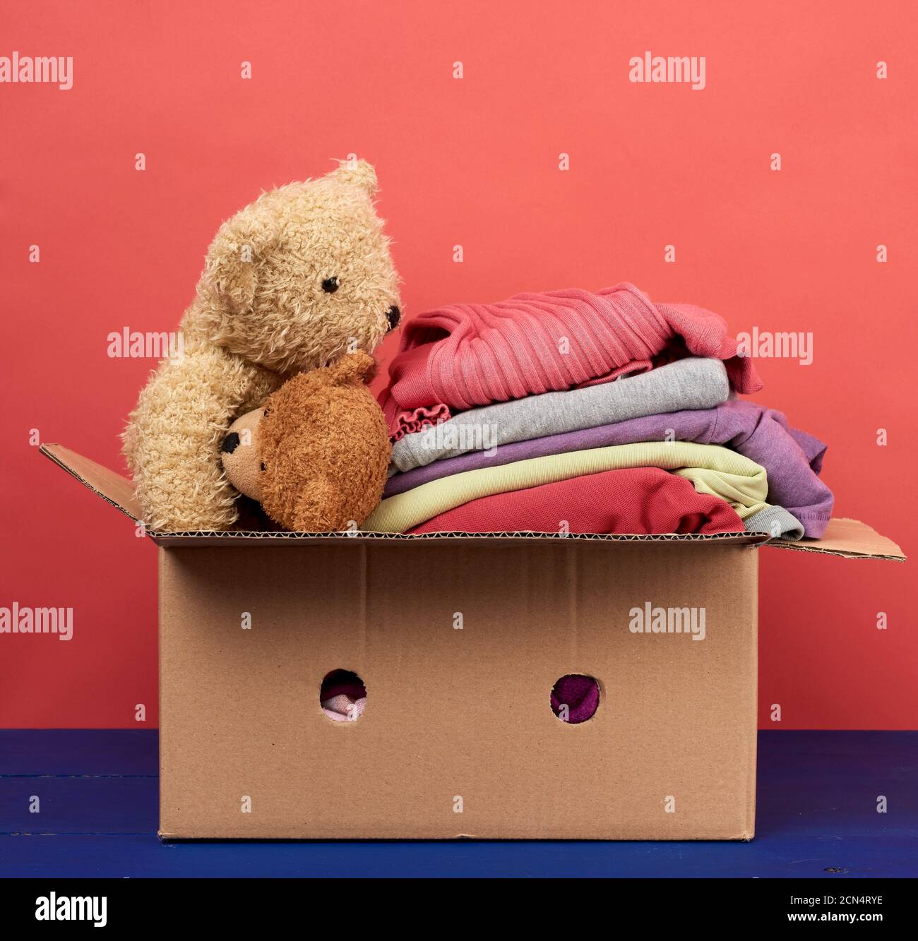 gran caja de cartón marrón llena de ropa y juguetes para niños Fotografía  de stock - Alamy