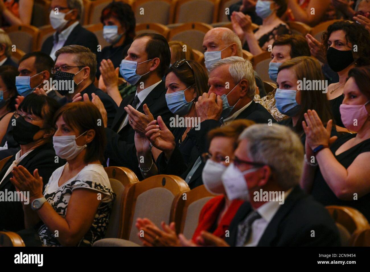 El público con máscaras protectoras escucha a la arpista Checa Jana Bouskova Y PKF - Praga Philharmonia actuar durante el concierto de Dvorak Praga int Foto de stock