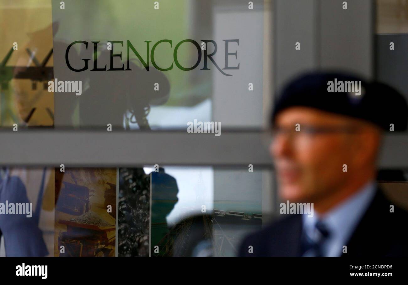 An employee of a private security company stands in front of the logo of commodities trader Glencore during the company's annual shareholder meeting in Cham, Switzerland May 24, 2017. REUTERS/Arnd Wiegmann Foto de stock