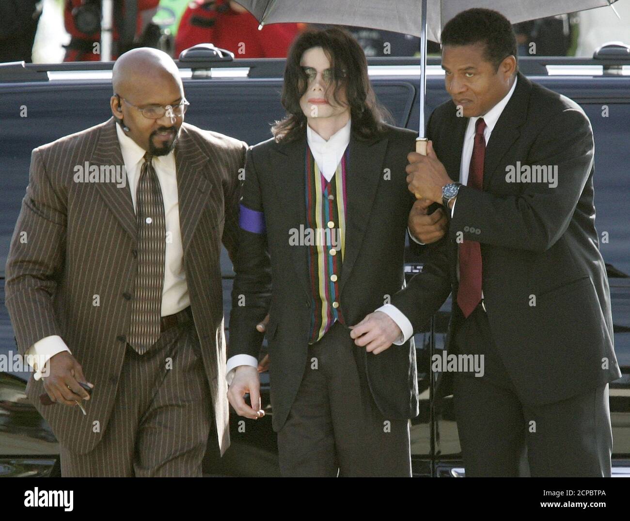 Pop star Michael Jackson is helped by his brother Jackie Jackson (R) and a  bodyguard (L) as he arrives at the Santa Barbara County Courthouse in Santa  Maria, California March 21, 2005.