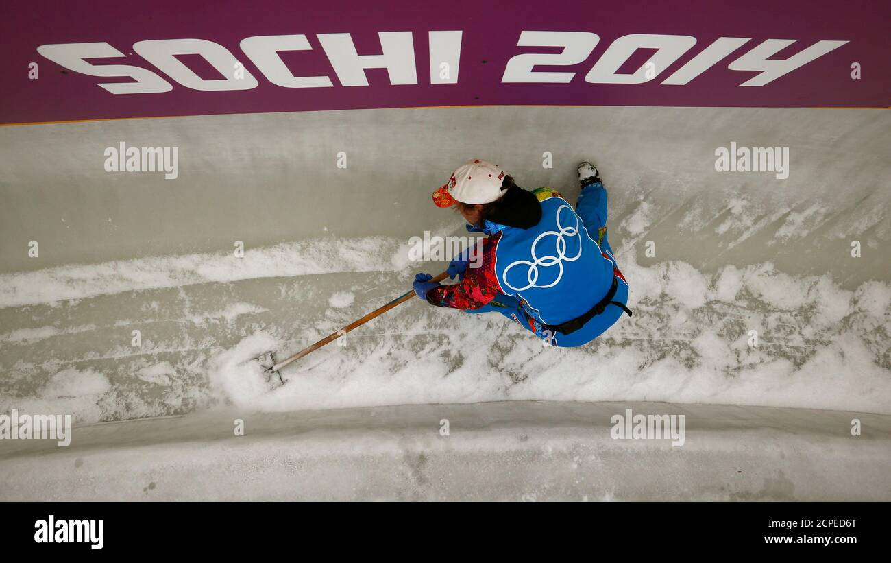 A worker prepares the ice track at the "Sanki" sliding center in Rosa  Khutor, a venue for the Sochi 2014 Winter Olympics near Sochi January 31,  2014. The "Sanki" sliding center will