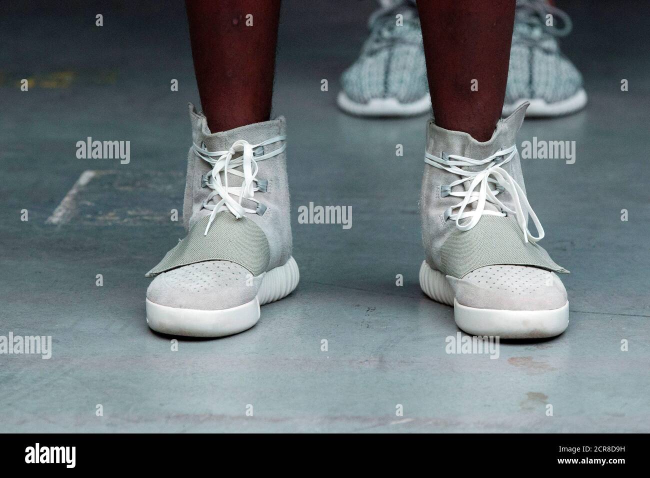A wears a pair of Adidas Yeezy 750 Boost shoes designed Kanye West as part of his Fall/Winter 2015 partnership line with Adidas at New York Fashion Week, U.S. February
