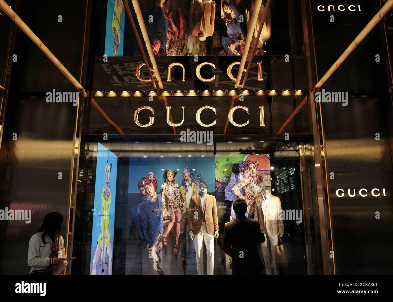 A man looks at a window display outside a Gucci store, part of the Kering  group, at Tsim Sha Tsui shopping district in Hong Kong January 17, 2013.  REUTERS/Bobby Yip/File Photo GLOBAL