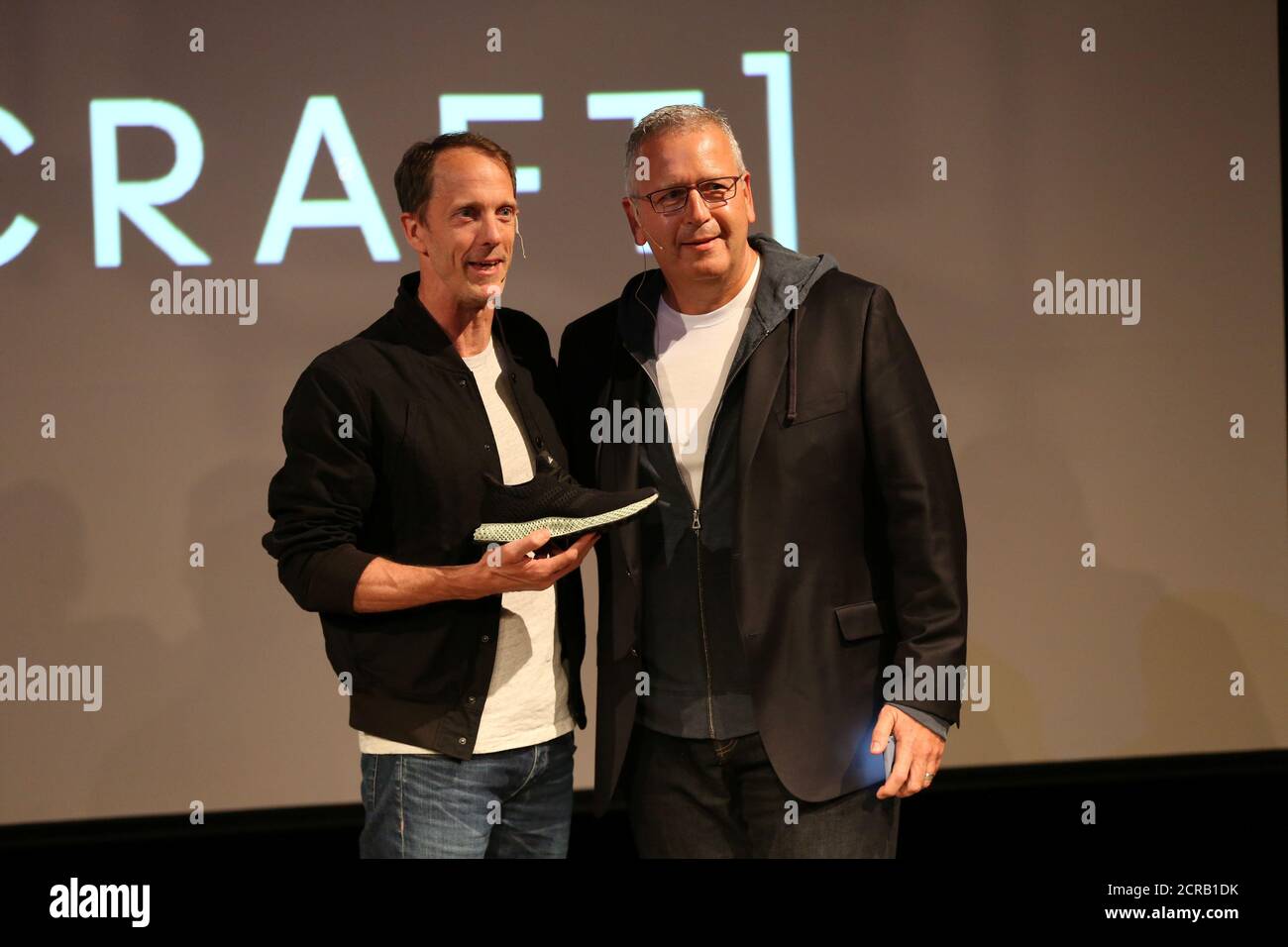 Adidas Executive Board Global Brands manager Eric Liedtke holds the new Futurecraft with Carbon 3D printing company CEO Joe DeSimone at an unveiling event New York City, New York, U.S.