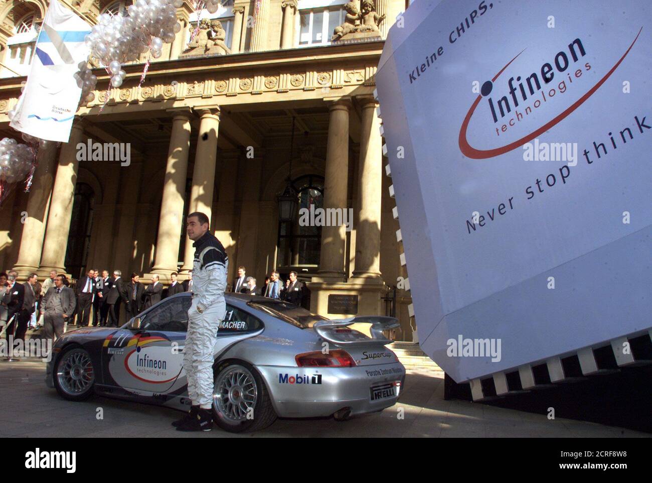 Ulrich Schumacher, CEO of German semiconductor company Infineon AG which  was floated on the stock market on Monday, March 13, poses in a racing  drivers outfit in front of a large semiconductor outside the Frankfurt  Stock Exchange. Shares in Infineon ...