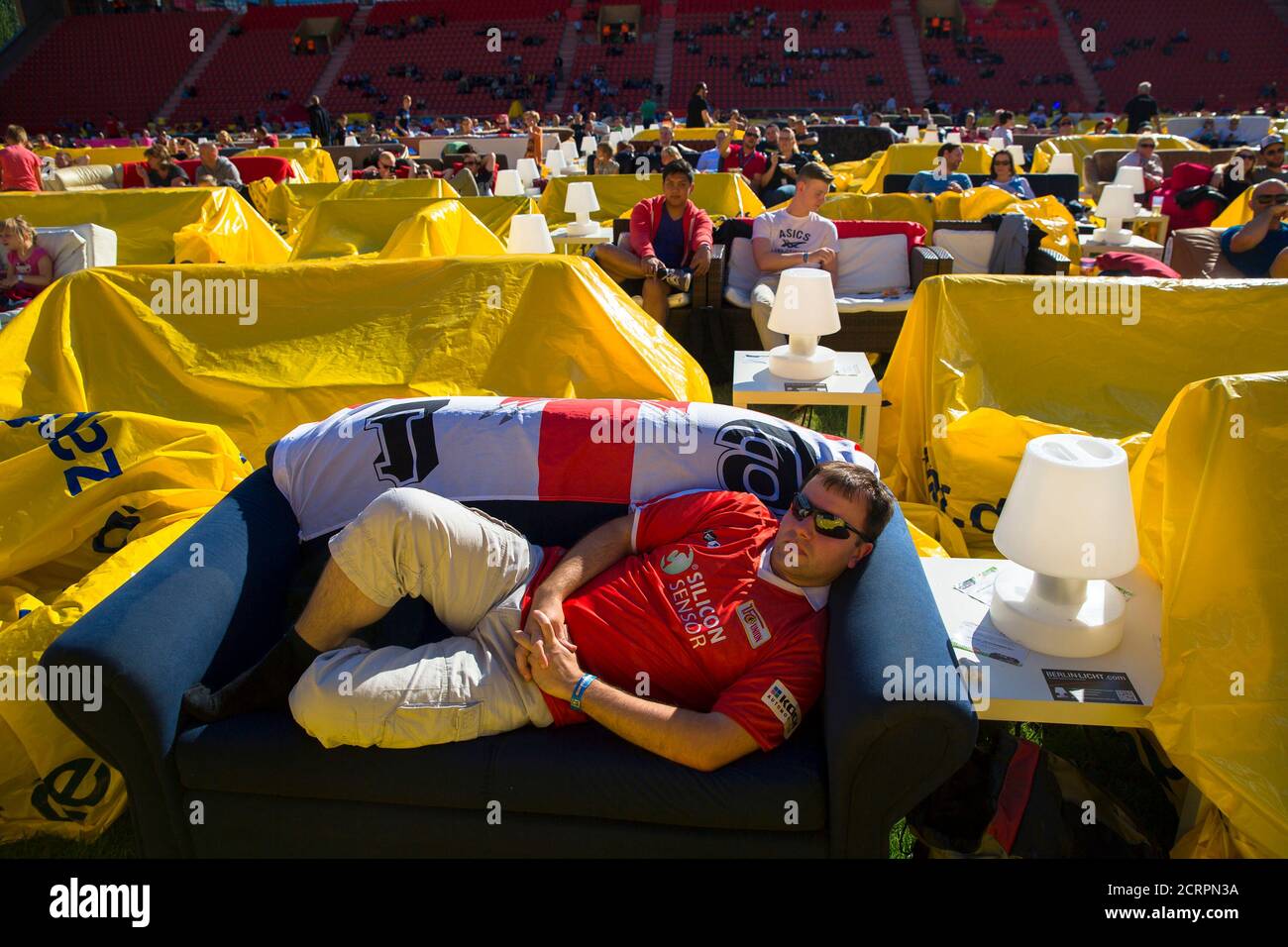 People sit on sofas as they watch a 2014 World Cup soccer match during a  public viewing event at the Alte Foersterei stadium in Berlin, June 15,  2014. Berlin's Union Berlin soccer