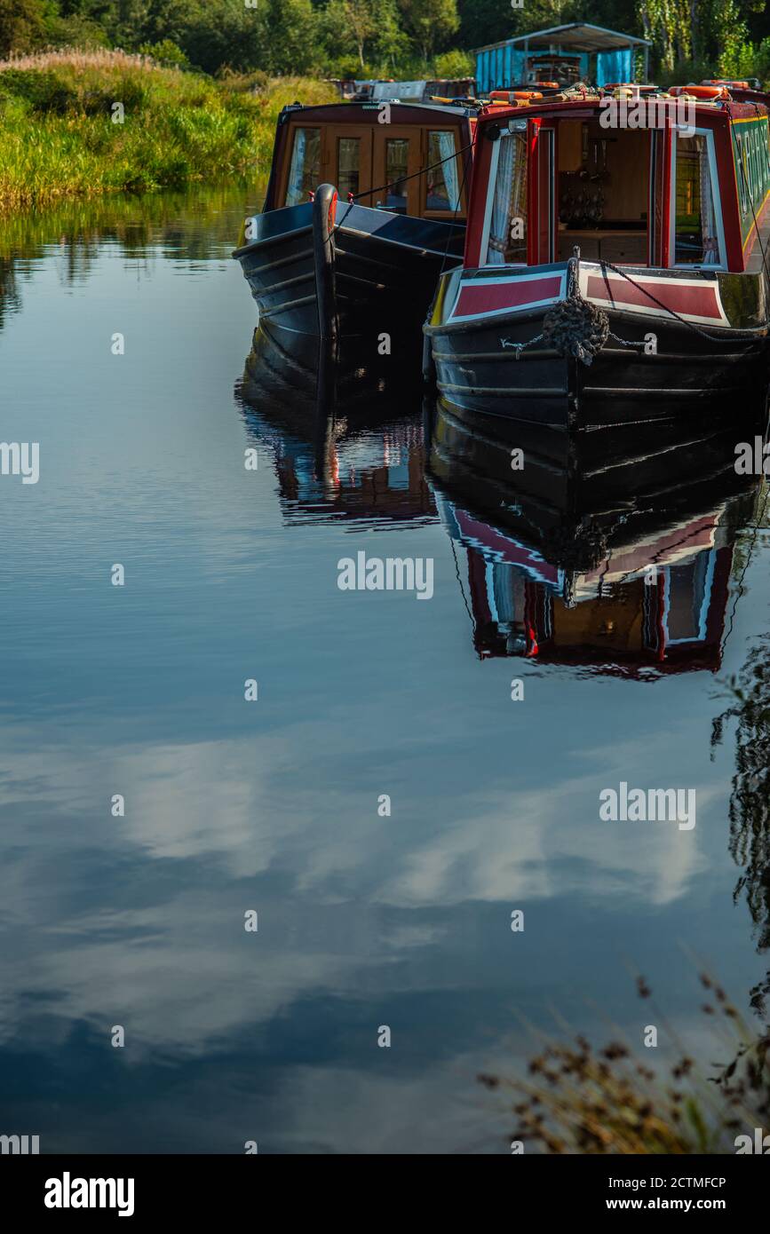 Los barcos del Canal y el cielo azul se reflejan en un canal tranquilo En verano Foto de stock