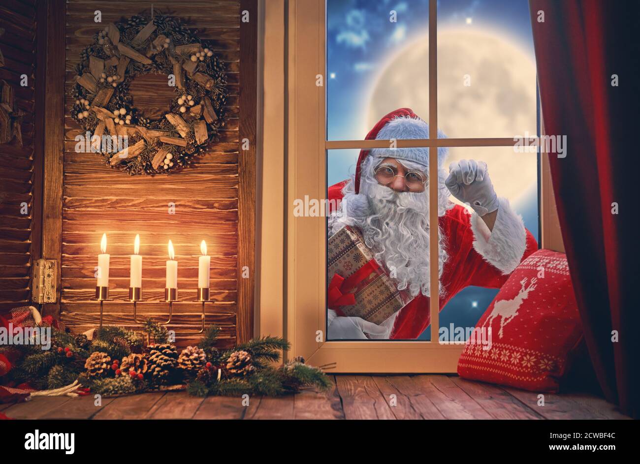 Feliz Navidad! Santa Claus llama a la ventana. Habitación decorada para  vacaciones. Ver casa interior Fotografía de stock - Alamy
