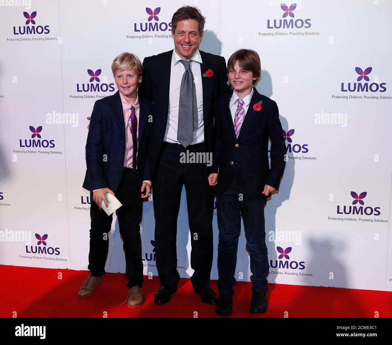 Actor Hugh Grant (C) poses with Damian Hurley (L), son of actress