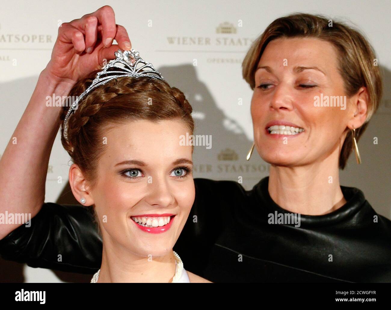Opera Ball organizer Desiree Treichl-Stuergkh touches the tiara of a  debutant during the jewelery presentation in Vienna January 28, 2014. The  traditional Vienna Opera Ball takes place on February 27.  REUTERS/Heinz-Peter Bader (