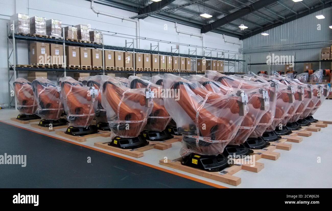 Robots covered in plastic sheets are seen at a plant of Kuka Robotics in  Shanghai August 13, 2014. China wants domestic companies to buy more  locally made robots to lift productivity, but