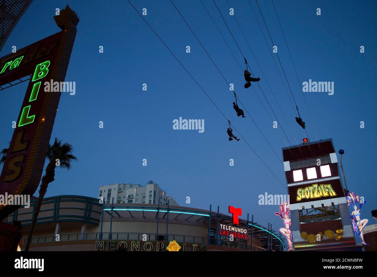 People try out the new 850-foot-long (259 meters) SlotZilla Zipline at the Fremont Street Experience in downtown Las Vegas, Nevada, April 30, 2014. A higher and longer 1700-foot (518-meter) Zoomline, which will propel flyers in a horizontal "superman" position at speeds up to 35 mph (56 kph) , is expected to open in June. The zip-line, part of the $12 million SlotZilla project, opened on April 27, 2014. REUTERS/Las Vegas Sun/Steve Marcus (UNITED STATES - Tags: TRAVEL SOCIETY) Foto de stock