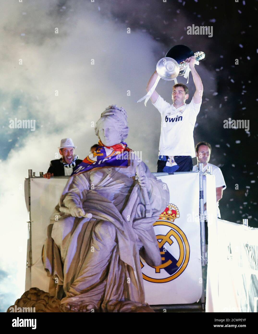 Real Madrid captain's Iker Casillas (R) and Sergio Ramos celebrate with the  trophy after winning their Champions League final soccer match against  Atletico Madrid, on top of the Cibeles statue in Madrid