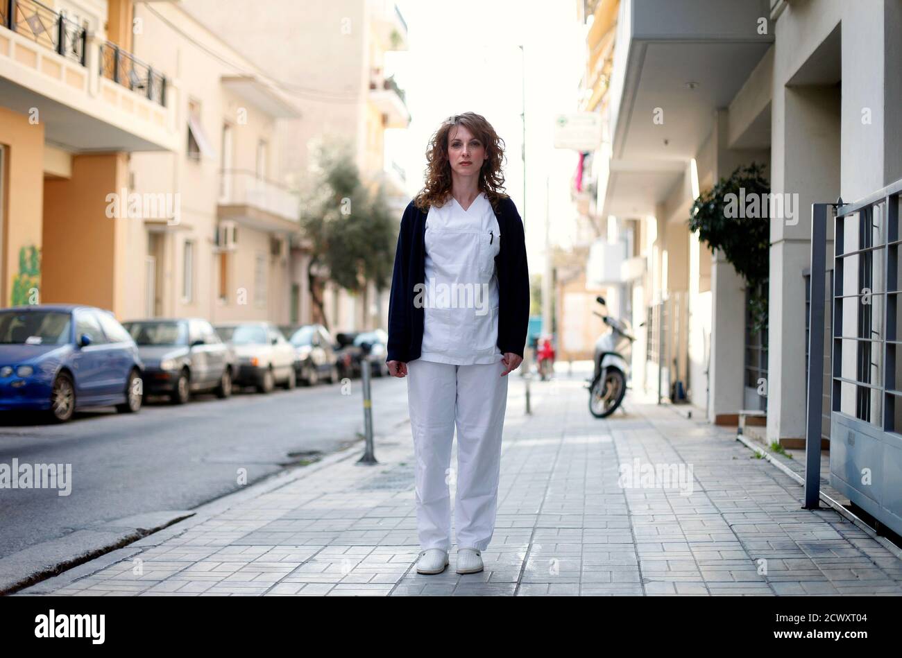 Pauline Delli, de 32 años, una enfermera psiquiátrica, se encuentra en la calle fuera de su lugar de trabajo en Atenas el 27 de marzo de 2012. Cuando se le preguntó cómo se había visto afectada por la crisis económica, Delli respondió: "Estoy viviendo día a día y no pensando en el futuro". Foto tomada el 27 de marzo de 2012. REUTERS/CATHAL MCNAUGHTON (GRECIA - TAGS: EMPRESA SOCIEDAD DE EMPLEO) ATENCIÓN EDITORES IMAGEN 7 DE 15 DEL PAQUETE 'RETRATOS DE GRECIA' Foto de stock