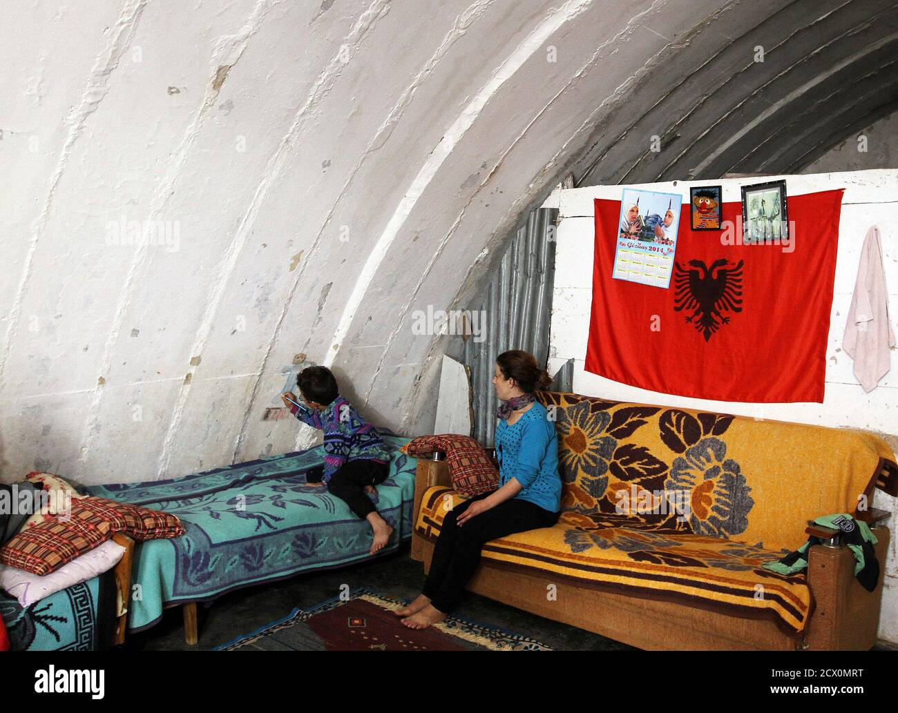 Florie Gjana R 30 Sits And Looks At Her Child Sajmir Who Paints On The Wall Of Their Communist Era Heavy Cannon Bunker Home Just Outside The Capital Tirana April 22 14 Marie Florie Gjana R 30 Sits And Looks At Her Child Sajmir Who Paints On The Wall Of Their Communist Era Heavy Cannon Bunker Home Just Outside The Capital Tirana April 22 14 Marie