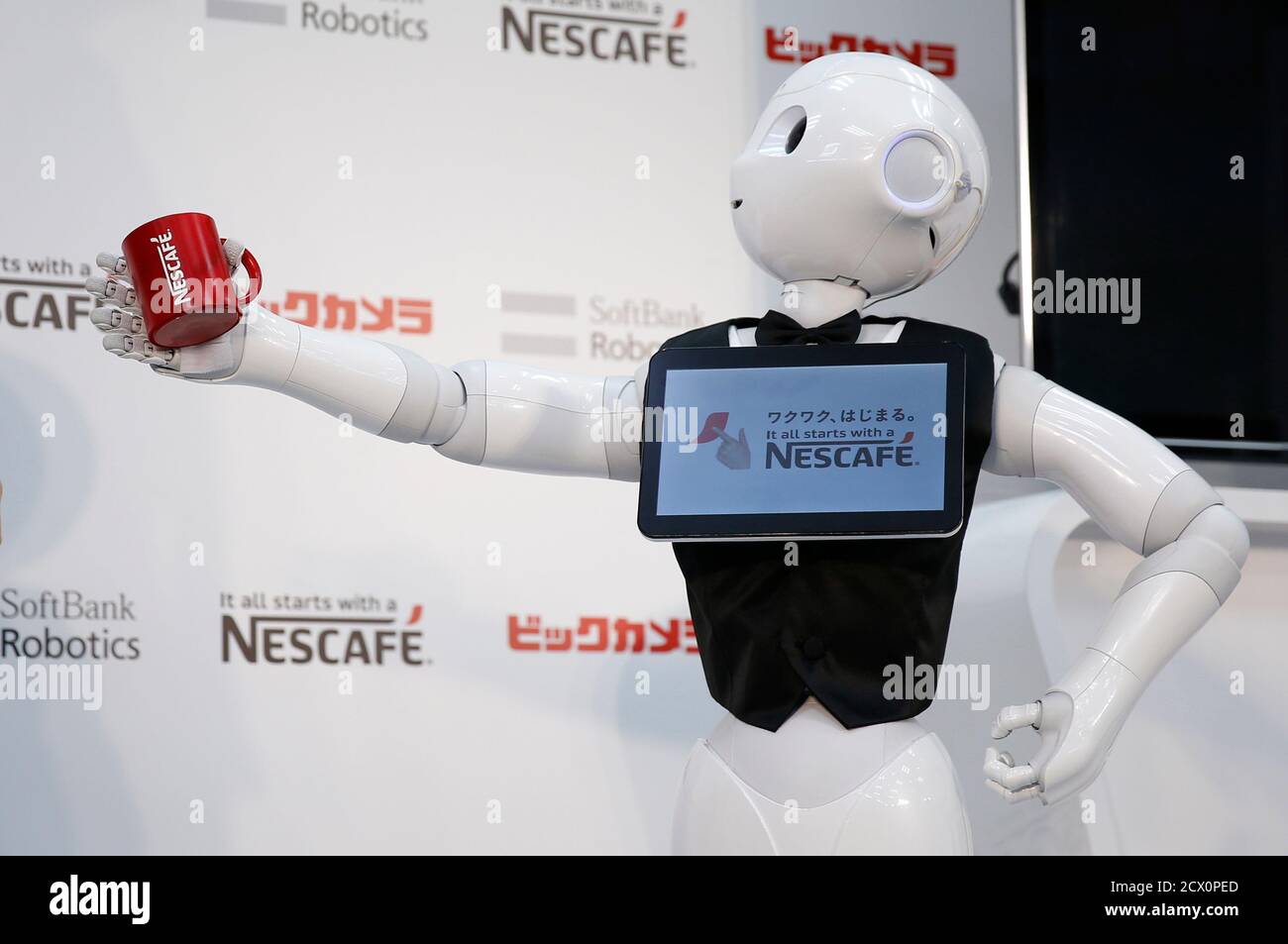 SoftBank Corp's human-like robot named "Pepper" introduces Nestle's coffee  machines during a promotion event at an electronics shop in Tokyo December  1, 2014. Nestle SA started to use robots to help sell