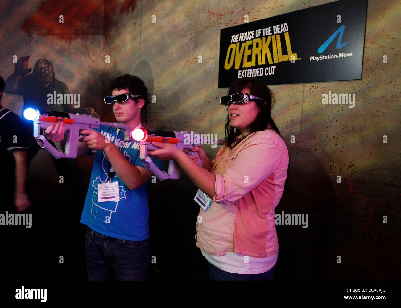 Two attendees play the new game The House of the Dead: Overkill, a  first-person rail shooter video game developed by Headstrong Games and  published by Sega for the Wii at E3 in