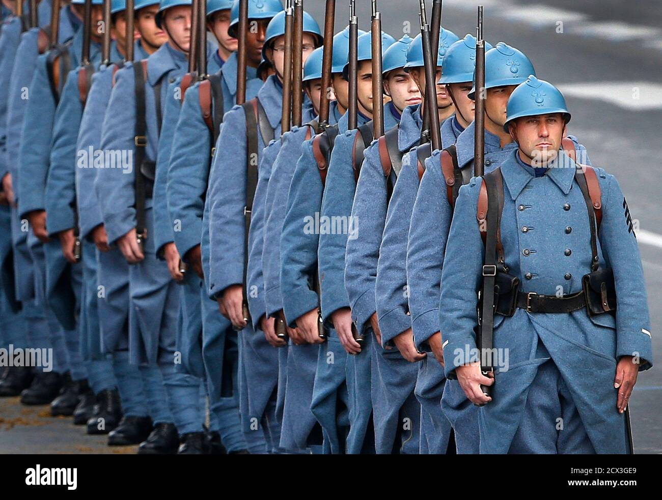 Soldiers wearing vintage French WWI army uniforms as Poilu (French soldier  in World War I) take part in the traditional Bastille Day parade on the  Champs Elysees in Paris, July 14, 2014.