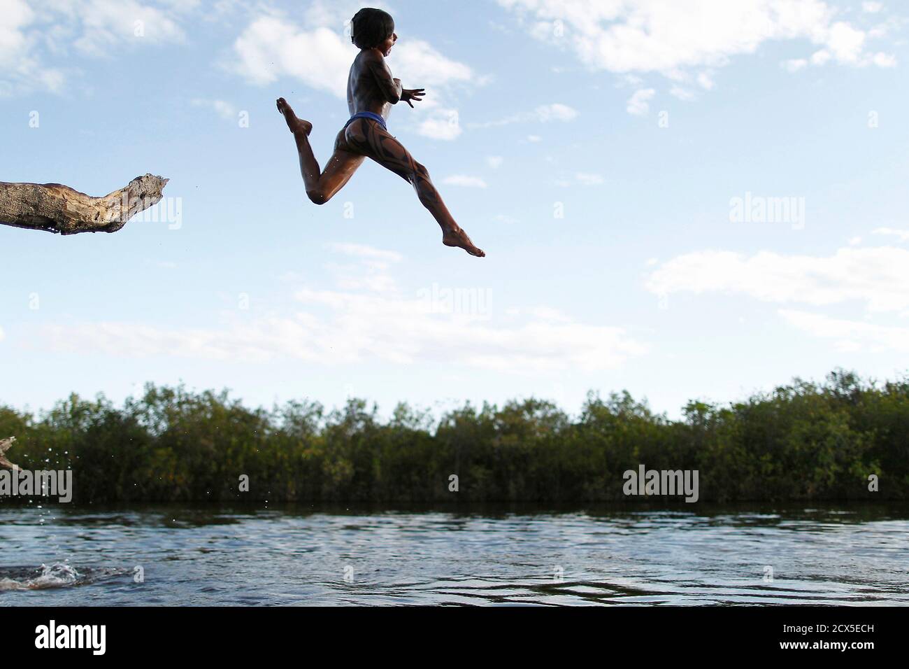 A Yawalapiti Boy Jumps Into The Xingu River In The Xingu National Park Mato Grosso State May 8 2012 In August The Yawalapiti Tribe Will Hold The Quarup Which Is A Ritual