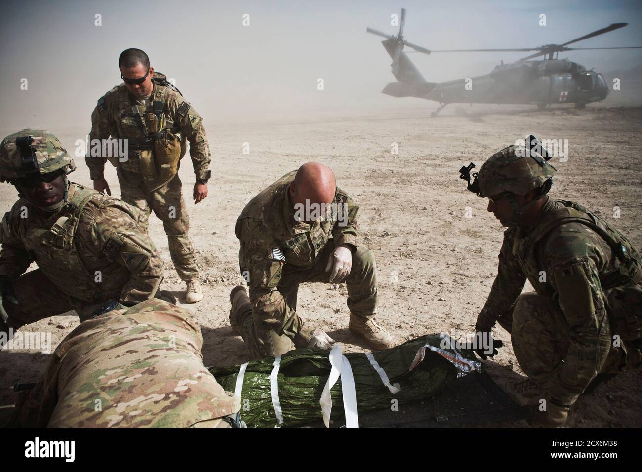 Soldiers From 1st Platoon Alpha Company 1st Battalion 36th Infantry Regiment Take Cover From A Helicopter S Rotor Wash While Evacuating A 10 Year Old Girl Injured By An Improvised Explosive Device Ied Which Detonated