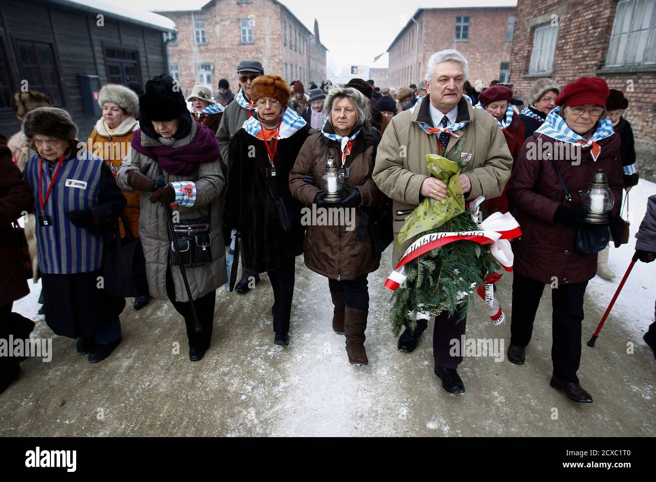 Former prisoners arrive to lay wreaths and flowers at the death wall of