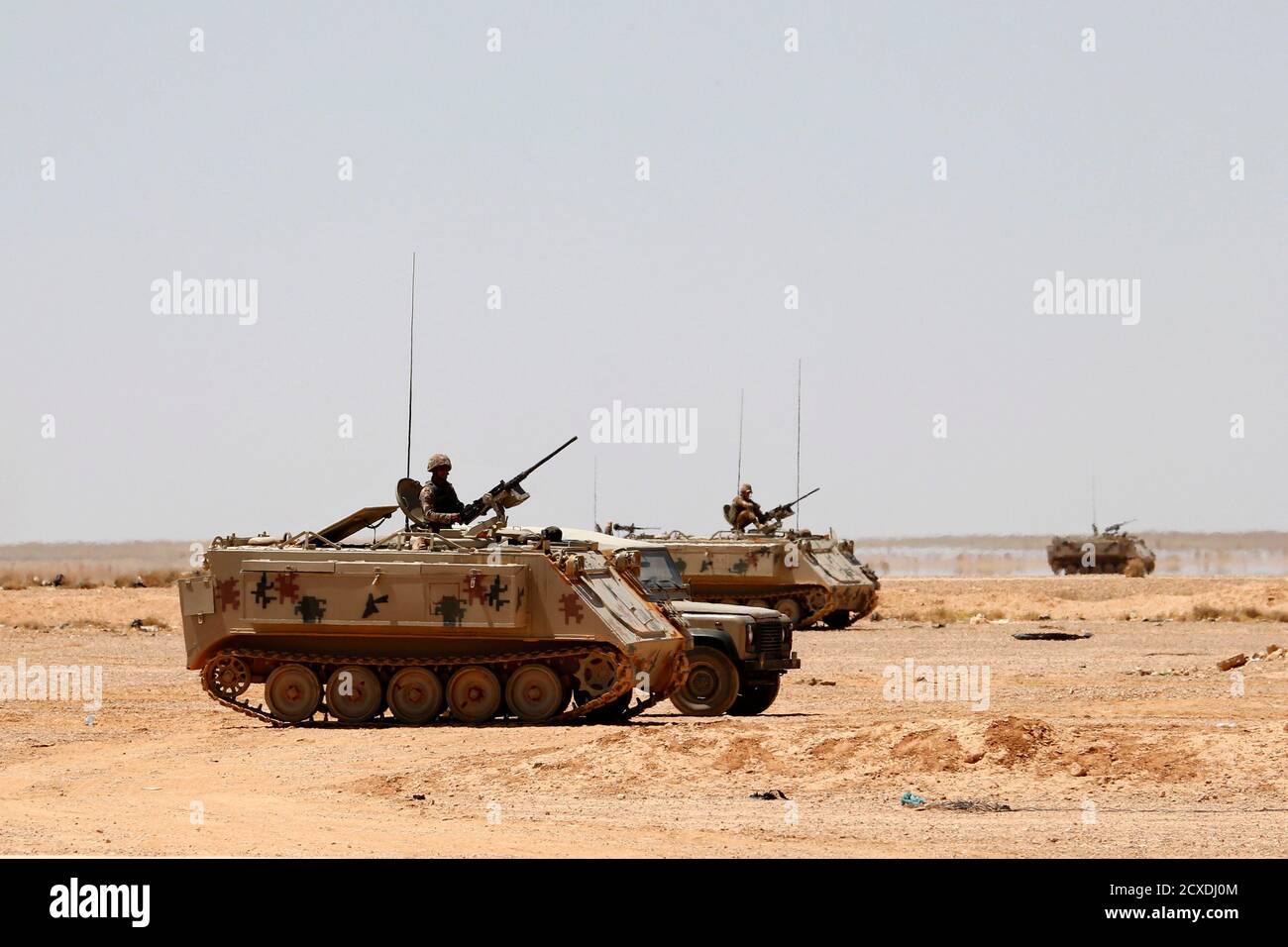 Jordanian soldiers in armoured vehicles stand guard near the Jordanian  Karameh border crossing on the Jordanian-Iraqi border, near Ruweished city,  June 25, 2014. REUTERS/Muhammad Hamed (JORDAN - Tags: POLITICS CIVIL UNREST  MILITARY
