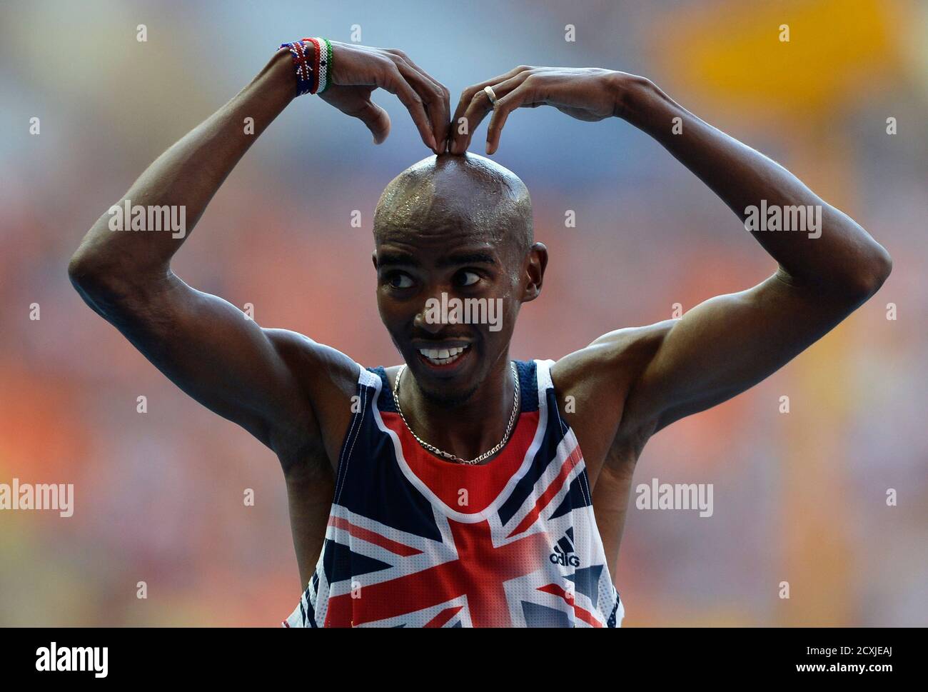 Mo Farah of Britian makes the 'Mobot' pose as he celebrates winning the  men's 10,000 metres final during the IAAF World Athletics Championships at  the Luzhniki stadium in Moscow August 10, 2013.