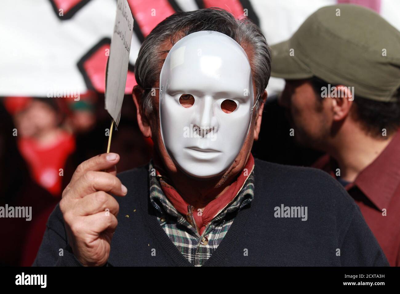 A demonstrator wears a mask during a protest marking the 1973 military coup  in Santiago, September 11, 2011. Sunday marks the 38th anniversary of the  coup d'etat in Chile that ushered in