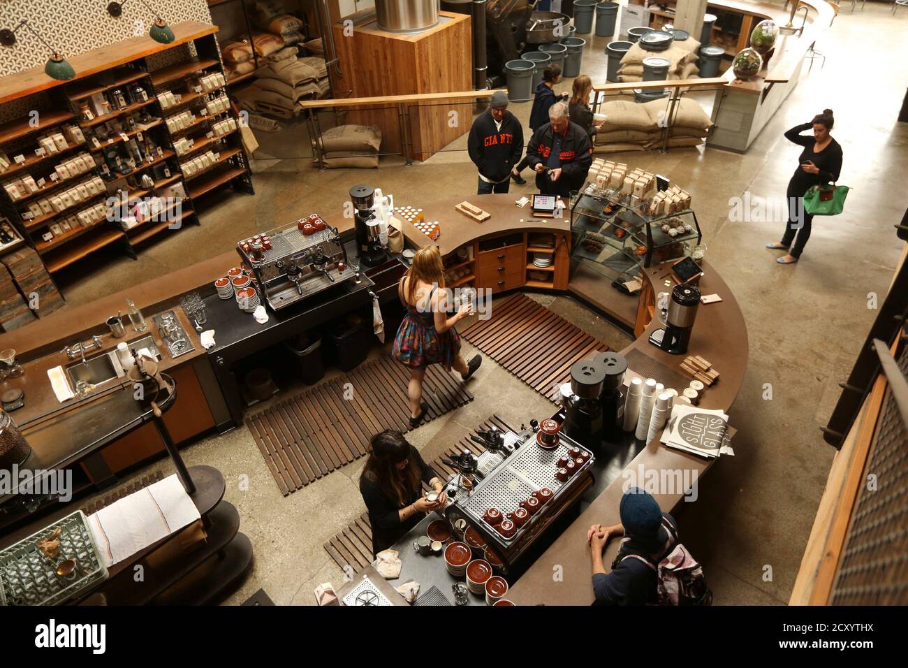 Customers wait to order their drinks at Sightglass, a coffee bar and  roastery, in San Francisco, California May 8, 2013. The new generation of  upscale coffee shops and roasters includes dozens of