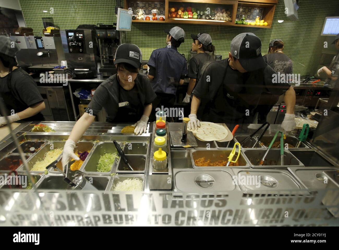 El personal trabaja en la cocina en el primer restaurante de comida rápida Taco  Bell en Japón en el distrito comercial Shibuya de Tokio el 21 de abril de  2015. La franquicia