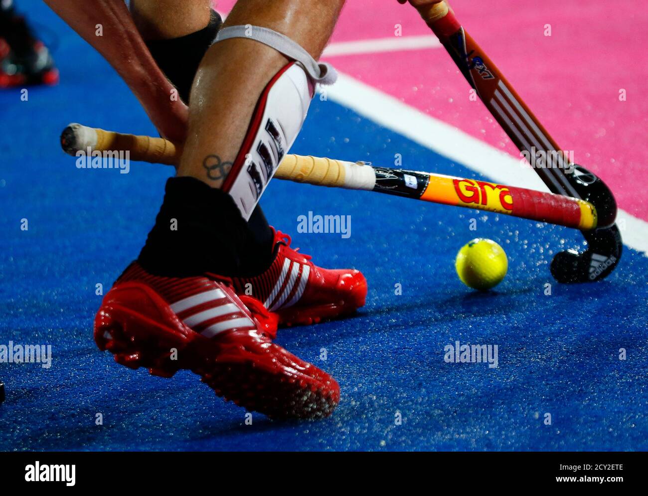Germany's Moritz Fuerste sports a tattoo on his right leg as he plays  against Belgium during their men's Group B hockey match at the London 2012  Olympic Games at the Riverbank Arena