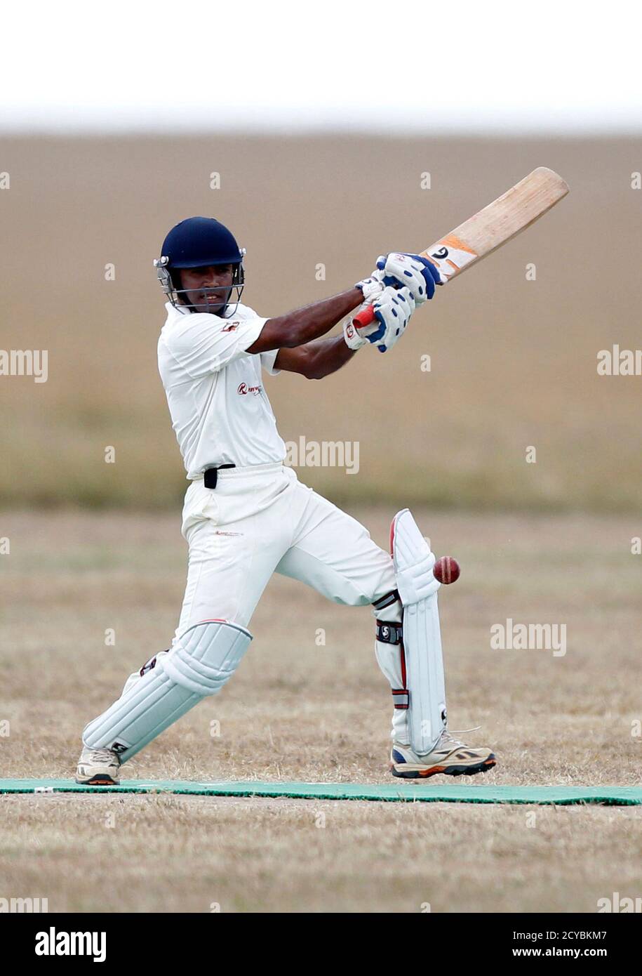 Vinayak Samant of the Ambassadors of Cricket from India plays a shot against the Maasai Cricket Warriors in a T20 cricket match in Ol Pejeta conservency in Laikipia national park, June 6, 2013. The Maasai Cricket Warriors are role models in their communities where they actively campaign against retrogressive and harmful cultural practices, such as female genital mutilation and early childhood marriages, while fighting to eradicate discrimination against women in Maasailand. Through cricket, they hope to promote healthier lifestyles and to also spread awareness about HIV/AIDS amongst youth. REU Foto de stock