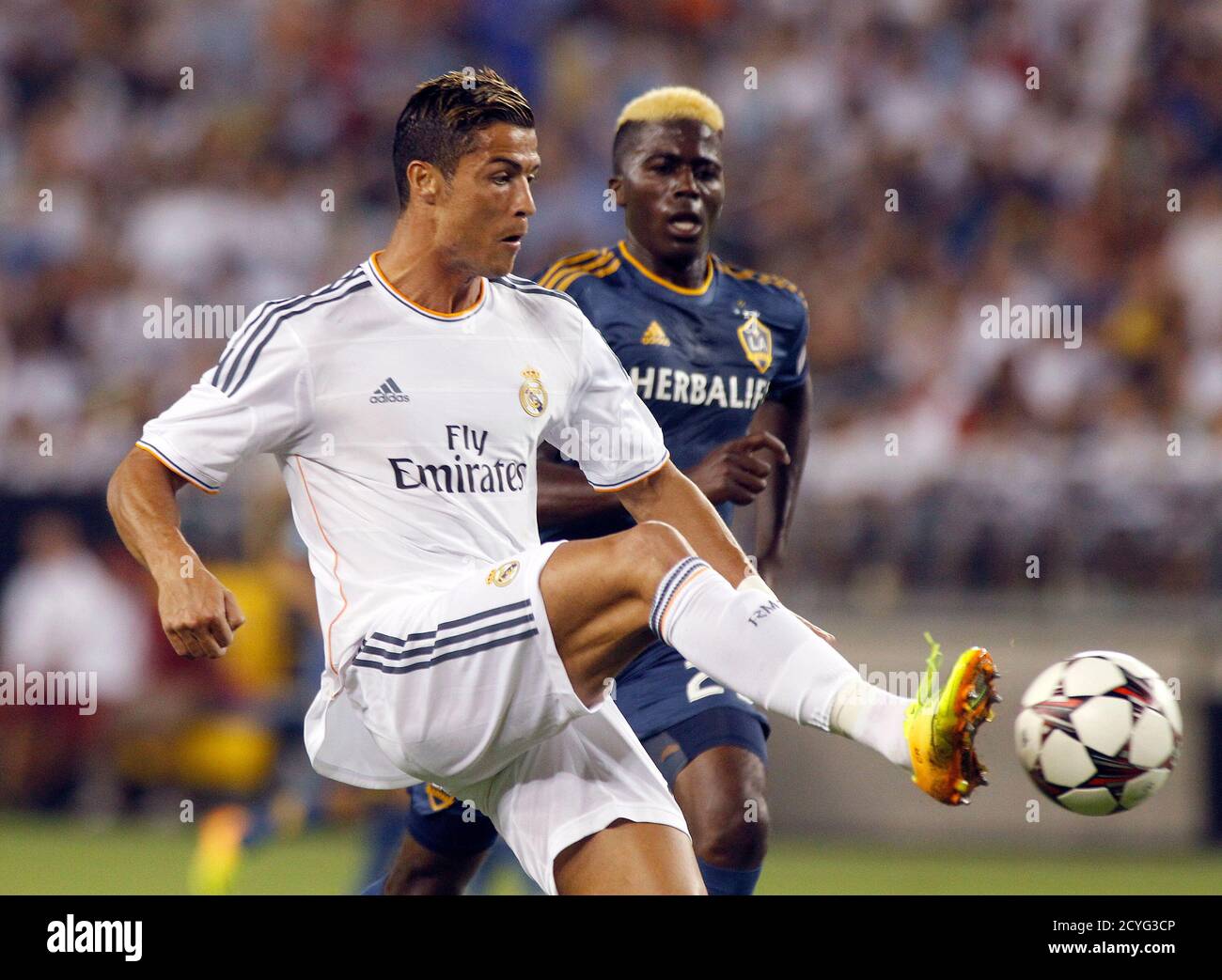 Real Madrid S Cristiano Ronaldo L Centers The Ball Past L A Galaxy S Gyasi Zardes To Teammate Angel Dimaria To Score During Their Guinness International Champions Cup Soccer Match In Phoenix Arizona August 1