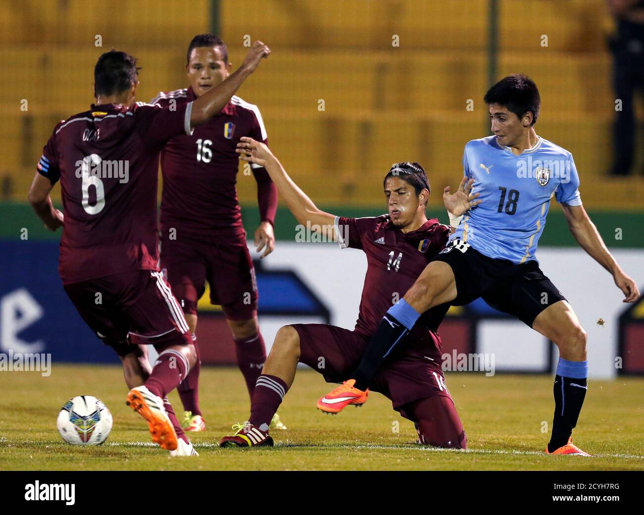 Uruguay's Franco Pizzichillo (R) competes for the ball with Venezuela's  Franko Diaz Graterol, Luis Jimenez Vivas and Ruben Alejandro Ramirez Dos  Ramos (L-2nd R) during their Group B soccer match at the