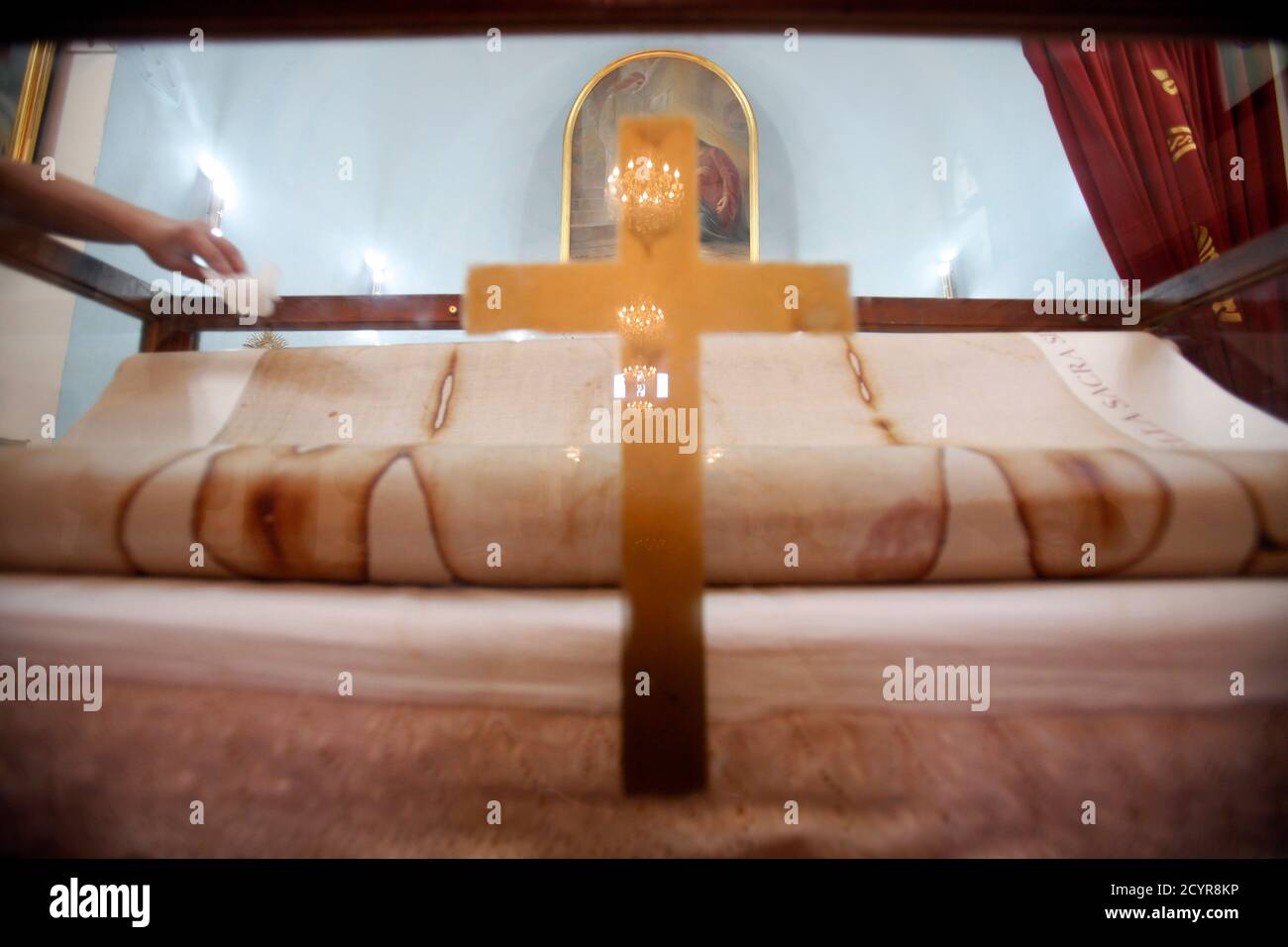A Man Touches A Copy Of The Original Shroud Of Turin On Display At An Armenian Catholic Church